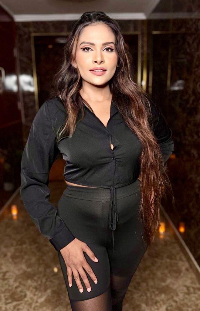 A dark-haired girl in tight shorts and a black shirt in the lobby of the spa center