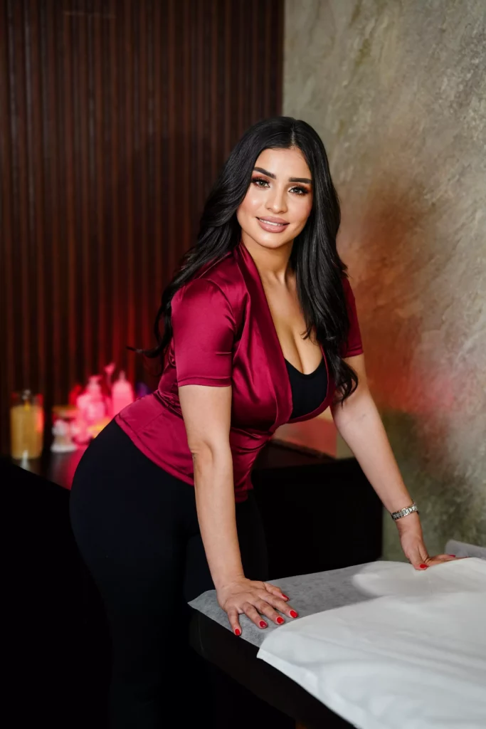 Brown-haired massage lady in red satin shirt